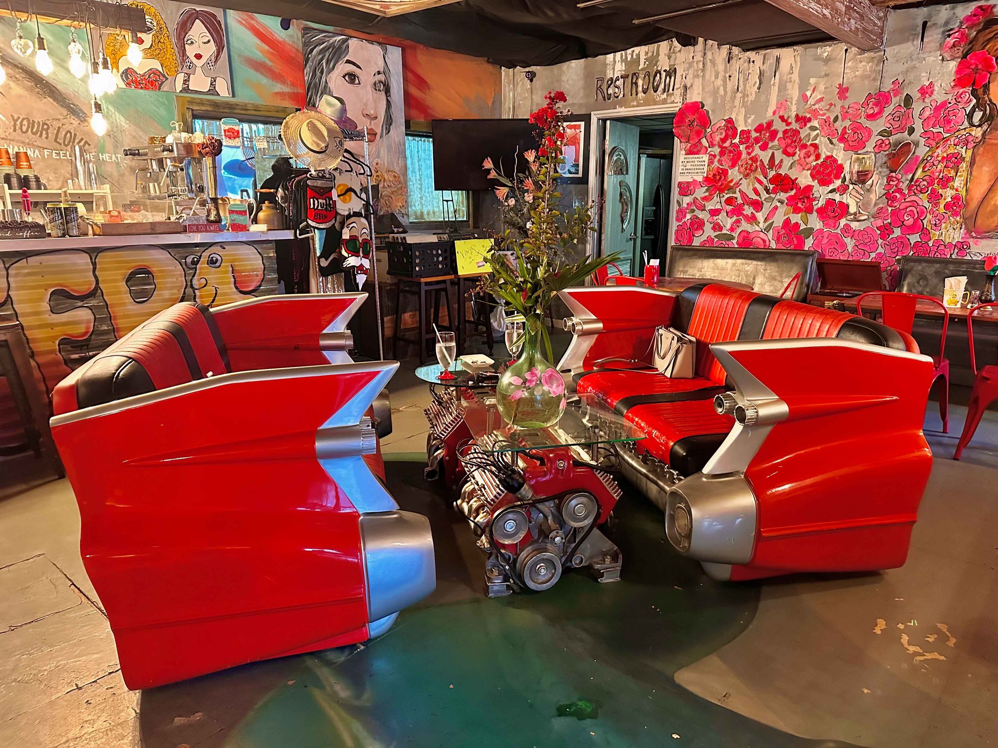 half of a corvette as sofas with a table and decor around